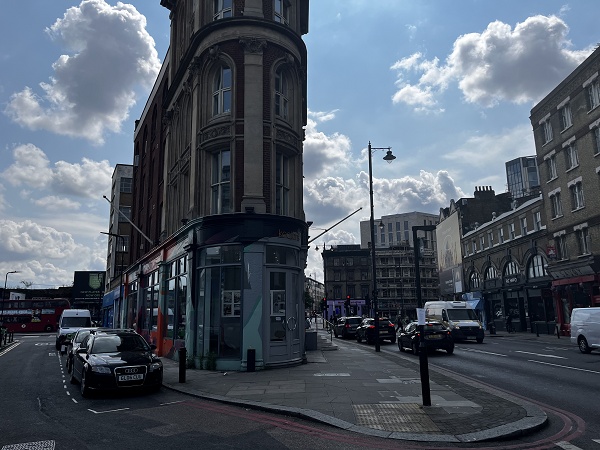 A side-street showcasing BOXPARK in the background