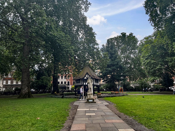 Tudor-style well and statue in Soho Square gardens.