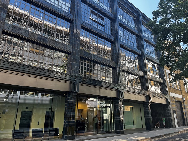Converted warehouse building with black tiled façade
