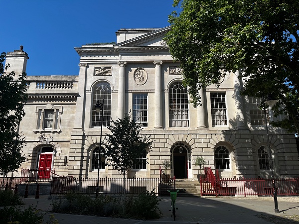 Georgian stone courthouse-style building with red doors